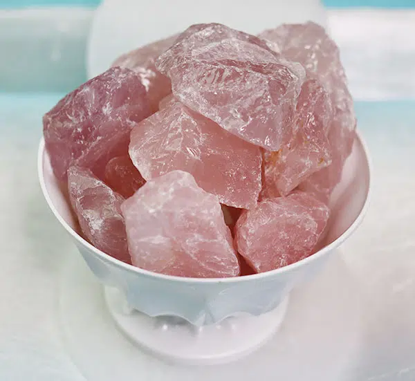 A bowl of raw rose quartz chunks