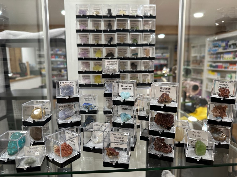 Labeled mineral specimens in display cases on a glass counter