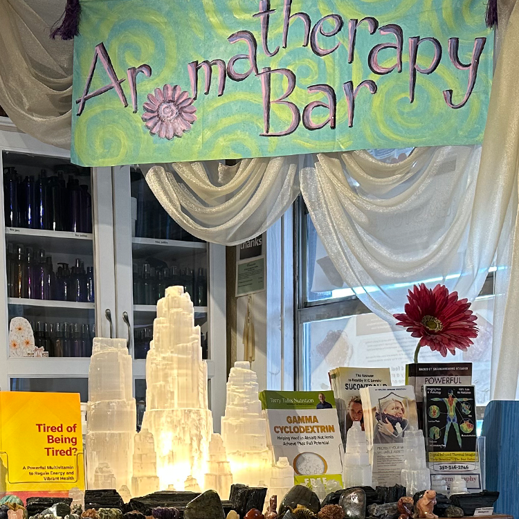 Rows of essential-oil bottles arranged at the Divine Wellness Aromatherapy Bar in Winter Garden