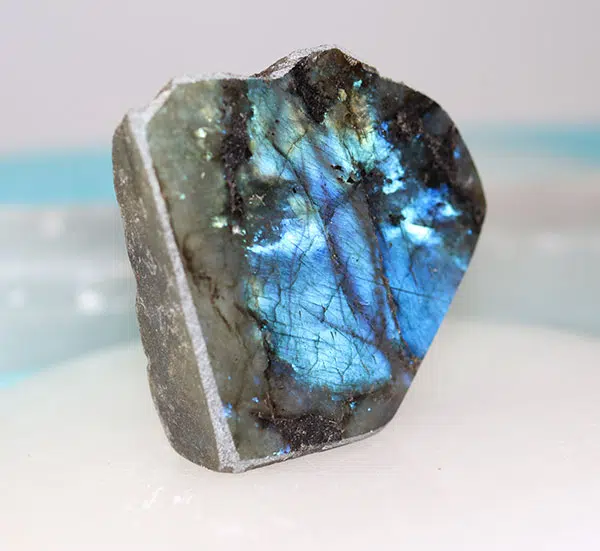 A raw labradorite chunk flashing iridescent blue