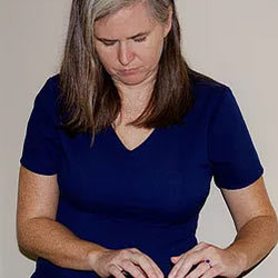 Katie Martinez, RN, in a navy top with a calm expression