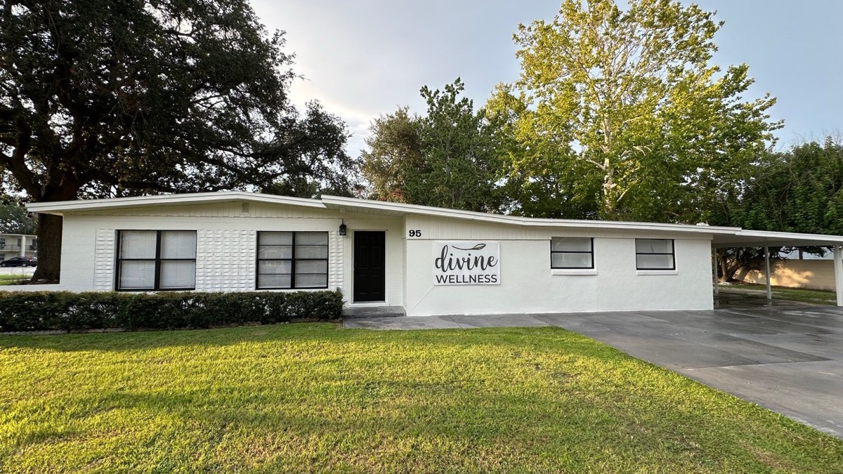 The Divine Wellness building at 95 E Palmetto St in Winter Garden, a white single-story building with the Divine Wellness sign by the front door