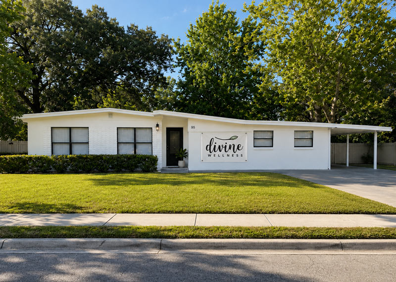 The new Divine Wellness building at 95 E Palmetto St, Winter Garden — a white mid-century storefront with the Divine Wellness sign out front