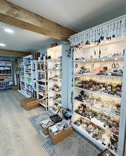 Inside the new Divine Wellness shop, with wooden shelves lined with gemstones, crystals, and wellness products
